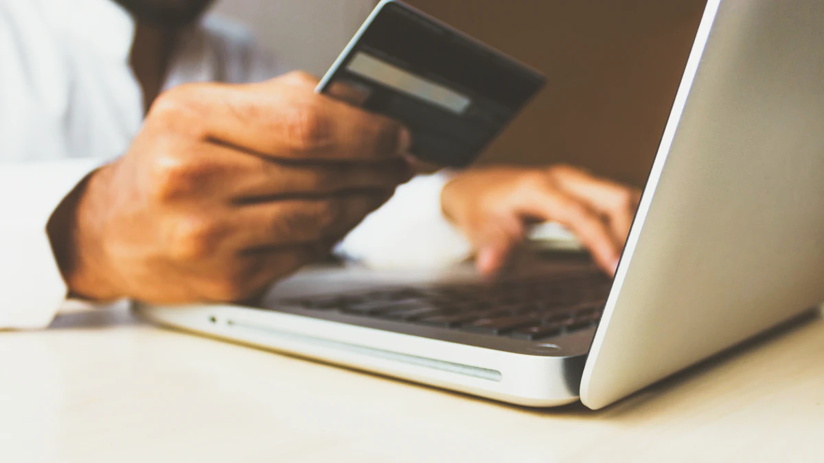 Customer shopping on an online store using a laptop and payment card
