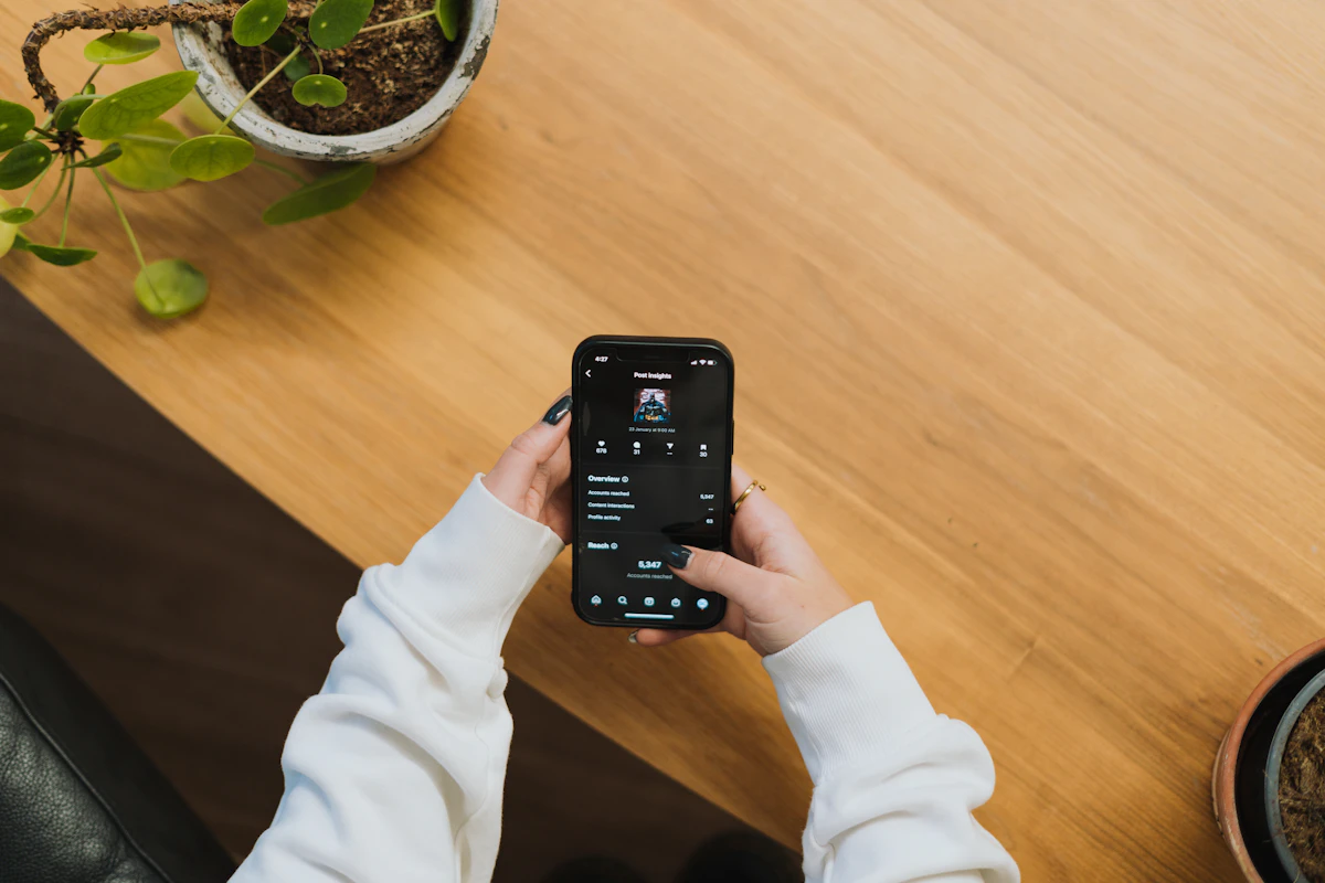 Business owner checking Instagram post insights on a smartphone
